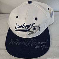Front view of white and navy Dallas Cowboys hat with Ed Too Tall Jones signature on brim