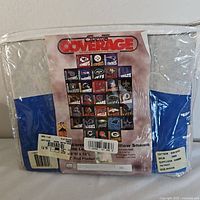 Front view of pillow shams in original packaging showing multiple NFL team logos including New England Patriots, Chiefs, Steelers, Titans, Jets, Colts, Raiders, Browns, Dolphins, Jaguars, Bills, Falcons, Packers, Ravens
