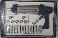 Clear plastic case containing a stainless steel cookie press and 12 imprint discs