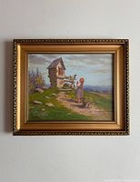 Front view of the oil painting depicting a girl near a small stone shrine in a pastoral landscape with a detailed gold frame.