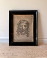 Full view of the framed print depicting the image of Jesus Christ known as the Sudarium of Saint Veronica, with black frame and gold inner edge.