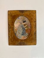 Full front view of the embroidered artwork set in a rectangular velvet-covered board.