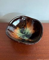 Top angle view of vintage pottery bowl showing colorful glossy glaze and triangular shape