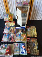 Full view of the lot showing a collection of Ty Beanie Babies in sealed original packaging alongside a damaged Danbury Mint Michael Jordan figurine box.