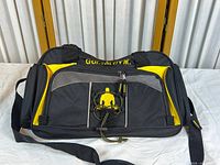Front view of Gold's Gym black and yellow gym bag with logo showing mesh compartment and drawstring accent.