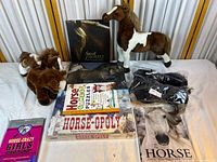 Image shows entire horse-themed lot including plush horses, multiple horse books, Horse-Opoly board game still sealed, and apparel items.