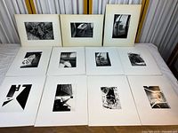 Set of 10 black and white matted photographs arranged on table showing sizes, mats, and photographic details.