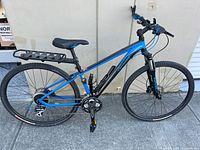 Full side view of blue and black Specialized mountain bike showing frame, wheels, crankset, handlebar and seat