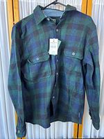 Full front view of the men's jacket hanging on a hanger, showing the checked pattern and button details.