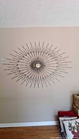 Full view of the metal starburst wall art mounted on a wall