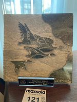 Front view of verdite marble plaque carved with flying birds, signed by David Bernett.
