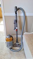 Front view of assembled vacuum with hose and wand