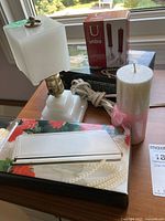 Photo showing lamp with square white glass shade, Umbra candle holder box, Studio Nova vanity set box, and pink and white pillar candle with bow