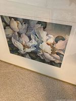 Front view of framed watercolor painting showing white floral composition