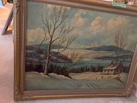 Full view of the signed original painting showing a snowy winter landscape with a cabin, bare trees, lake, and hills under a cloudy sky in an ornate frame.