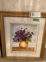 Full view of the framed flower still life painting with a 12x10 size label and Maxsold tag.
