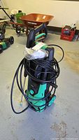 Full view of green and black Yardlab pressure washer with hose and handle visible.