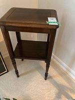 Front and side views of the wooden side table, showing overall design and wear.