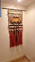 Full front view of wall hanging showing overall design and fringe