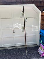 Overall view of lamp showing full wood pole, three shades and brass accents.