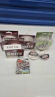 Top view of all fishing line packages and spools in the lot including Sufix and Berkley Trilene