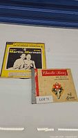 Front cover photo of two vinyl album covers: Mary Martin & Ethel Merman duet on Decca Records with a yellow background and a black and white photo of the artists, and Charlie Kunz His Piano and Christmas album cover next to it.