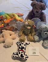 Top view showing all six Ty Beanie Baby Minis, including Sammy in case, puppies, and teddy bears laid out together on light-colored surface.