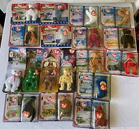 Full lot displayed on white table showing all 22 Ty Teenie Beanie Babies in original packaging, illustrating lot completeness and condition.