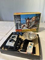 Brownie Starflex camera with strap, flash reflector, four flashbulbs, and a roll of Potomak film in original box.