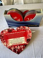 Top view of the heart-shaped case with 34 red DVDs titled I Love Lucy in a blue box labeled The Complete Series