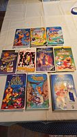 Full set of 10 Disney VHS tapes laid out on a white surface, showing front cover art for each movie.