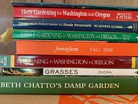 Spine view showing titles: Herb Gardening for Washington and Oregon, Timber Press Pocket Guide to Shade Perennials, Edible Gardening for Washington and Oregon, Forestfarm Fall 2006, Gardening in Washington & Oregon, Grasses, Beth Chatto's Damp Garden.