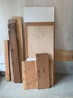 View showing stacked wood pieces including plywood, 1x4 and 1x6 boards