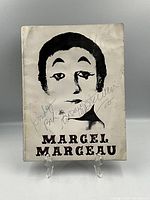 Front cover with mime illustration and autograph