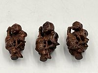 Front view of all three wooden netsuke figurines