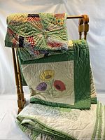 Quilt rack with quilts draped showing patterns