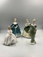 Front view of all four Royal Doulton figurines