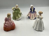 Front view of all four Royal Doulton figurines