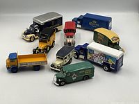 Overall group of 9 diecast beer advertising vehicles