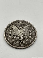Reverse of 1899 O Morgan dollar showing eagle and denomination