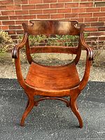 Front view of mahogany curved seat chair showing arms, seat, legs and backrest