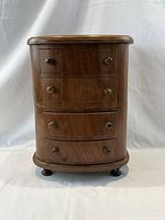 Front view of miniature bow front chest, drawers closed