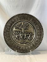 Front view of entire charger showing relief scene and ornate border