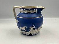 Full left profile showing relief hunting scene and handle