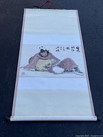 Full view of entire scroll showing borders, painting, dowels