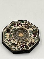 Full view of octagonal Feng Shui compass showing painted surface and central compass