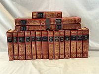 All 19 Oxford Illustrated Dickens volumes standing in two rows