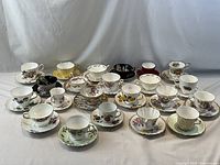 All 22 teacup and saucer sets lined in rows