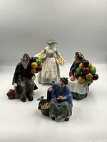 Front view of four Royal Doulton figurines grouped