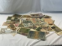 Pile of assorted banknotes and travel papers spread on surface